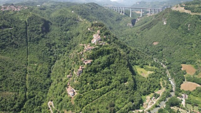 Laino Castello, the Lao River at its base and Italia viaduct in the background